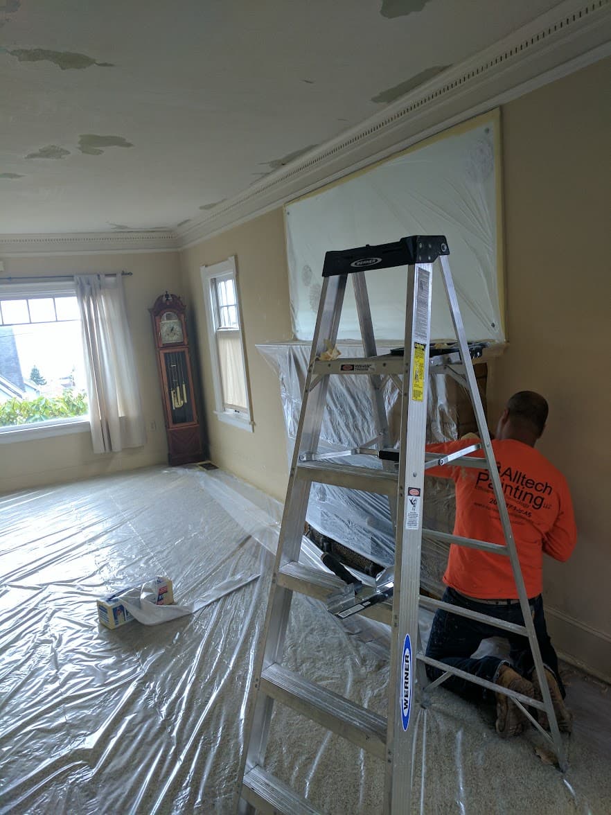 Alltech Painting crew preparing and protecting an interior space before painting in Queen Anne